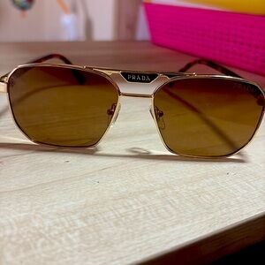 Prada Sunglasses 
Pale gold/ polarized dark brown